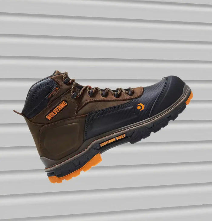 Brown and black Wolverine waterproof work boot with orange accents.